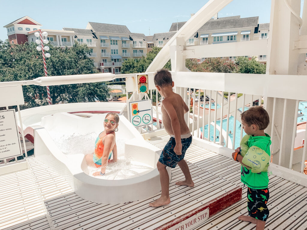 3 kids going down water slide