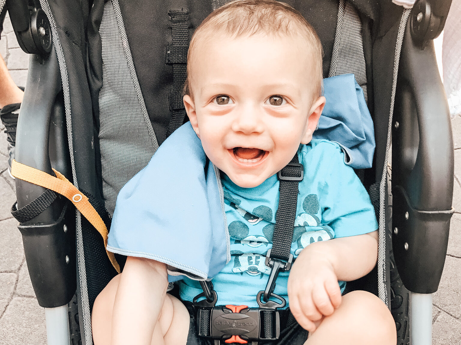 baby in stroller with cooling towel